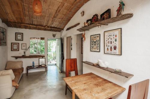 Una sala de estar con una mesa de madera y un sofá. en Casa blanca, Refugio Natural Jacaranda, en Cocorná
