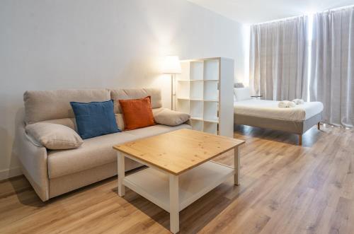 a living room with a couch and a coffee table at The Urban Studio Madrid in Madrid