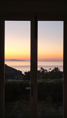 an open door with a view of the ocean at Alta Marina in Marciana Marina