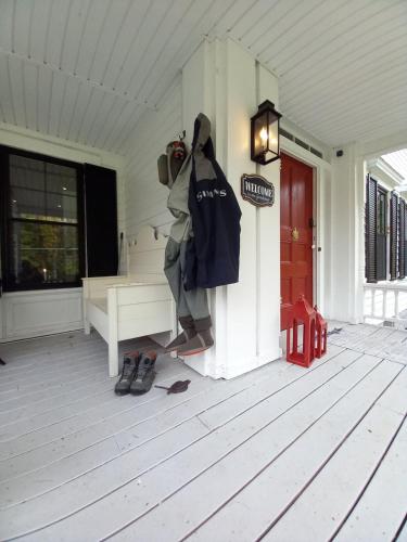 a coat hanging on the side of a house at Schoolhouse Suite in Altmar