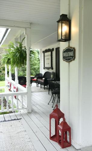 a sign on the side of a porch with a piano at Schoolhouse Suite in Altmar