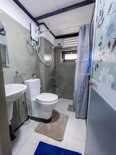 a bathroom with a toilet and a sink at Serenity Home Stay in Kandy