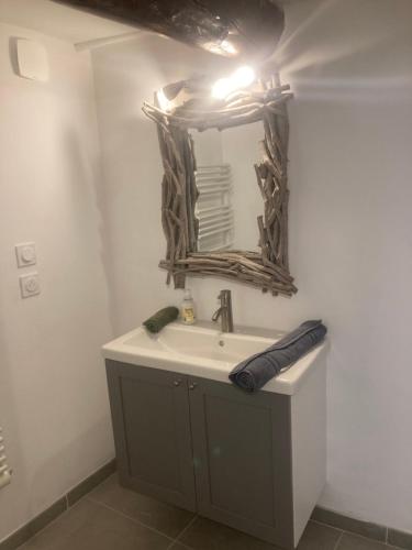 a bathroom with a sink and a mirror at La Tanière du Ventoux in Bédoin