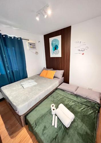 a small bedroom with a bed and a green rug at The Sos Staycation in Davao City