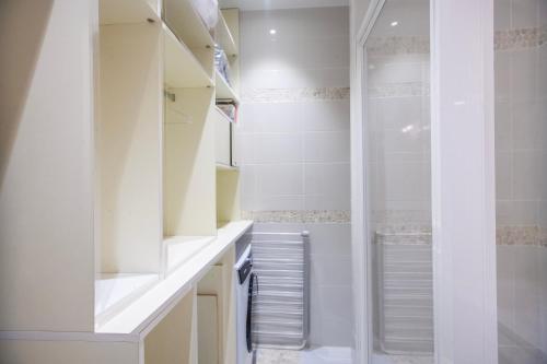 La salle de bains est pourvue d'armoires blanches et d'une douche. dans l'établissement Centre-ville, proche port, à La Ciotat