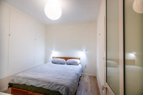 une petite chambre avec un lit et un miroir dans l'établissement Centre-ville, proche port, à La Ciotat