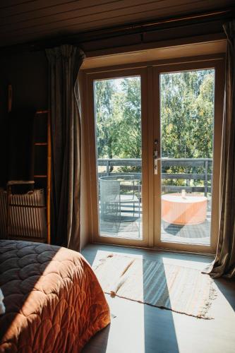 a bedroom with a window with a view of a balcony at The Falcon Hotel in Allinge