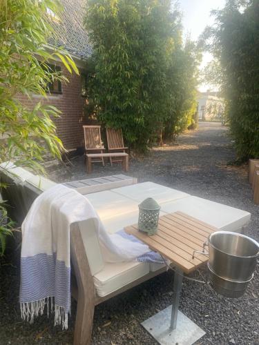 a picnic table and a bench in a yard at The Beach House & Winter Wonderland in Schellinkhout