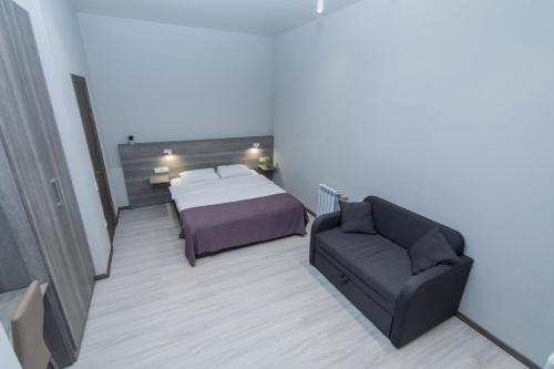 a bedroom with a bed and a couch at Seven Apart Hotel in Vyshneve