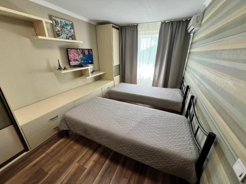 a small room with two beds and a window at Seven Apart Hotel in Vyshneve