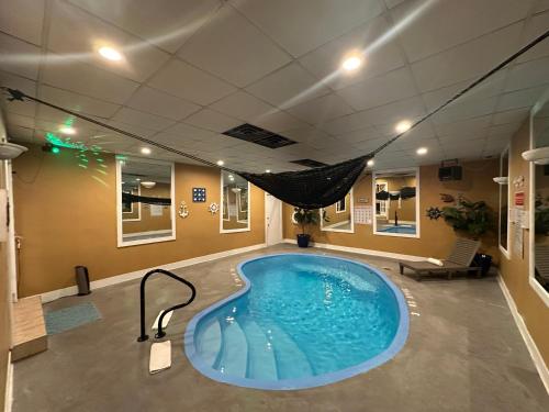 a hot tub in a room with a hammock in it at Inn of the Dove - Romantic Luxury Suites with Jacuzzi & Seasonal Fireplace at Harrisburg-Hershey-Philadelphia, PA in Harrisburg