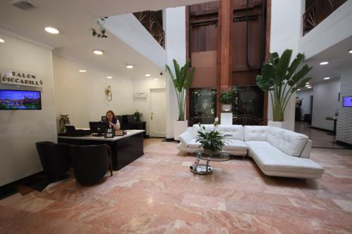 a woman sitting at a desk in a lobby at Lancaster House in Bogotá