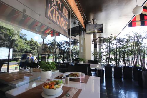 a restaurant with a table with a bowl of food at Lancaster House in Bogotá