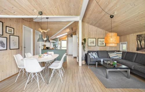 a living room with a couch and a table at Holiday Home Røllikevej Tranekær V in Skattebølle