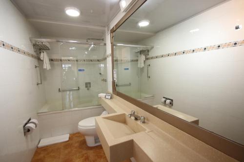 a bathroom with a sink and a toilet and a shower at Lancaster House in Bogotá