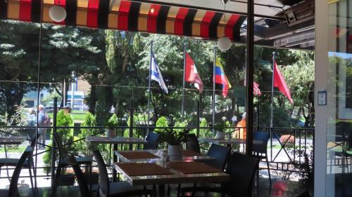 a row of tables with flags in a restaurant at Lancaster House in Bogotá