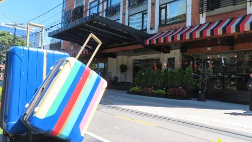 a pair of suitcases sitting on the side of a street at Lancaster House in Bogotá