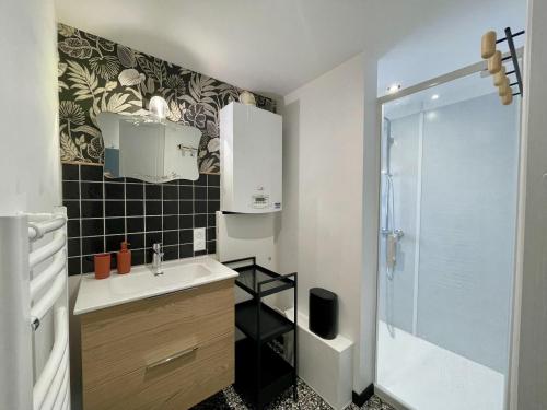 een badkamer met een wastafel en een douche bij Villa Georgette in Saint-Gilles-Croix-de-Vie