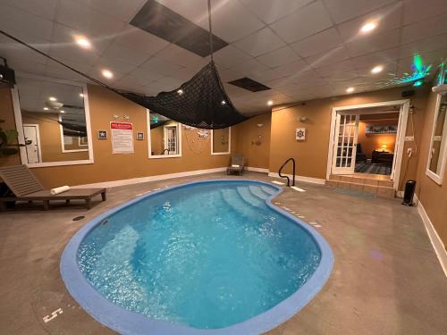 a large swimming pool in the middle of a room at Inn of the Dove - Romantic Luxury Suites with Jacuzzi & Seasonal Fireplace at Harrisburg-Hershey-Philadelphia, PA in Harrisburg