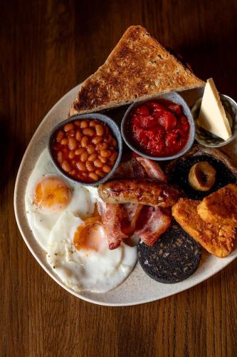 a plate of breakfast food with eggs beans and toast at The Dragon in Willington