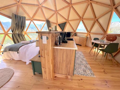 a room with a bed and a table in a yurt at L'étoile du Béarn in Asson