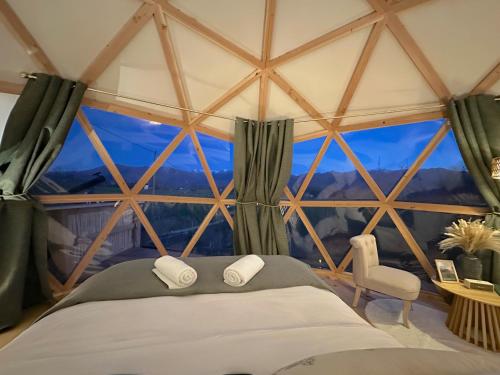 a room with a bed and a large window at L'étoile du Béarn in Asson