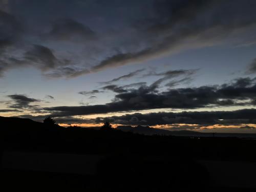 a sunset with dark clouds in the sky at Creag Mhor Lodge in Arisaig