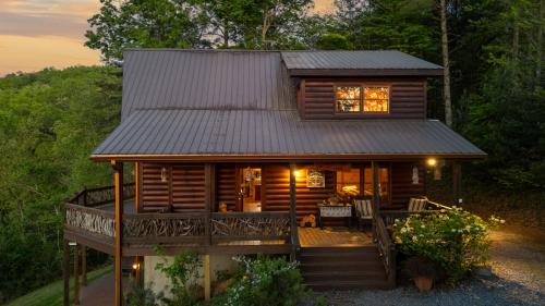 a log cabin with a porch and a deck at Majestic View in Mashburn Mill