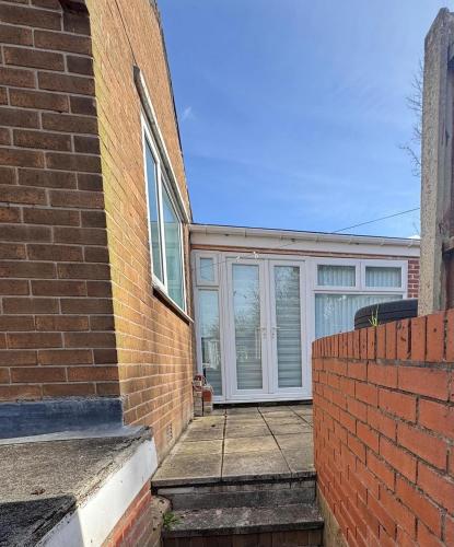 a brick building with a white garage door at Modern 3-Bed Family Home in Quiet Sheffield Area in Wincobank