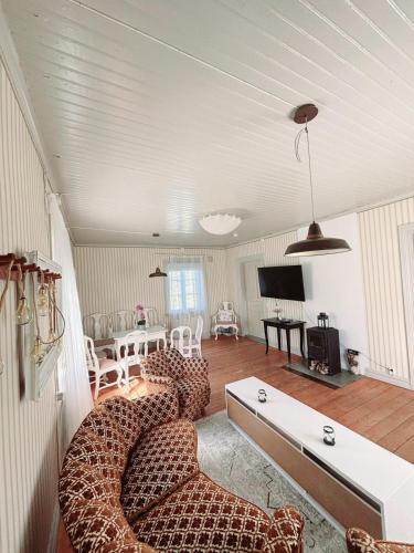 a living room with two couches and a tv at Norrqvarn Hotel & Resort by Vänerport in Lyrestad