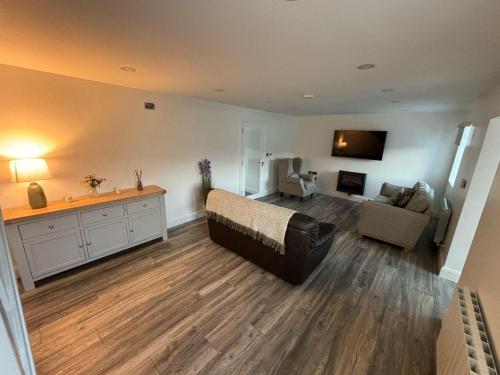 a large living room with a bed and a couch at Nature Lovers Family Home - 3 Bed 2 Bath in Colthurst Bridge