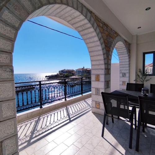 a balcony with a table and a view of the ocean at Selini Apartments Mani in Agios Nikolaos