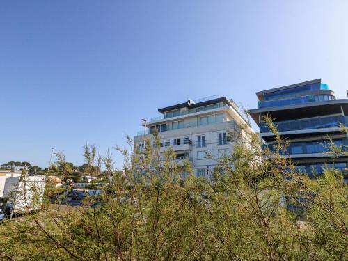 a tall white building with trees in front of it at Flat 7 Sand Acres in Poole