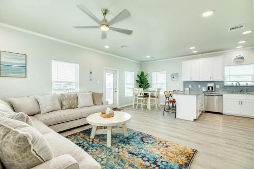 a living room with a couch and a table and a kitchen at Paradise Found - Great Location - Family Friendly in Surfside Beach