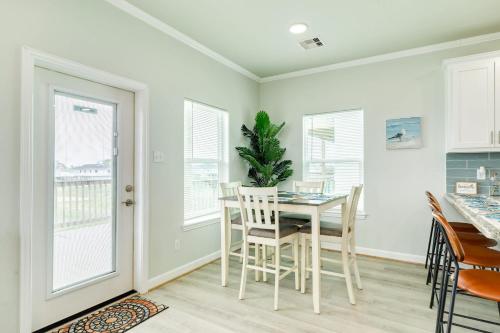 a dining room with a table and chairs and windows at Paradise Found - Great Location - Family Friendly in Surfside Beach