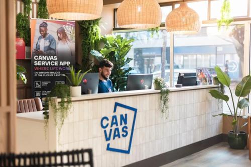 a restaurant counter with a sign that says can was at Canvas The Old Fire Station Birmingham in Birmingham