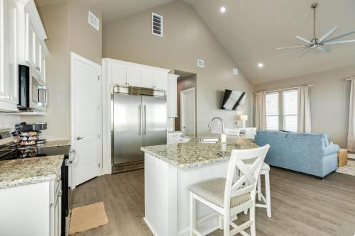 a kitchen and living room with a refrigerator and a table at Sea Holly - Beachfront - Pet & Family Friendly in Freeport
