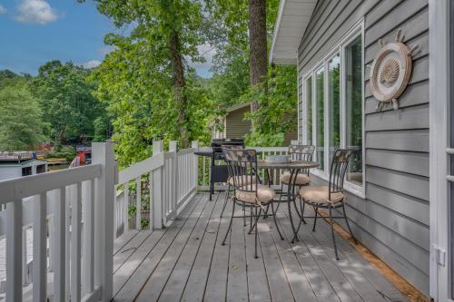 a deck with chairs and a table on the side of a house at Waters Edge Hideaway Lakefront Pet Friendly in Lake Lure