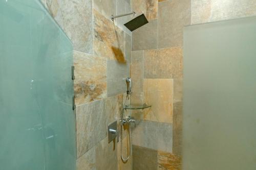 a shower with a glass door in a bathroom at Hotel San Bada Resort & Spa in Manuel Antonio