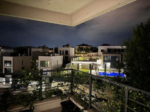 a view of a city at night from a balcony at Luxury Stay surrounded by Nature in Tirana