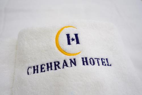 a white shirt with the words henwegian hotel on it at Chehran Hotel in Samarkand