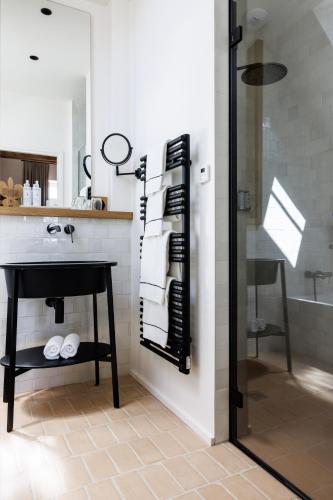 a bathroom with a shower and a sink and a counter at Domaine de Locguénolé & Spa - Relais & Chateaux in Kervignac