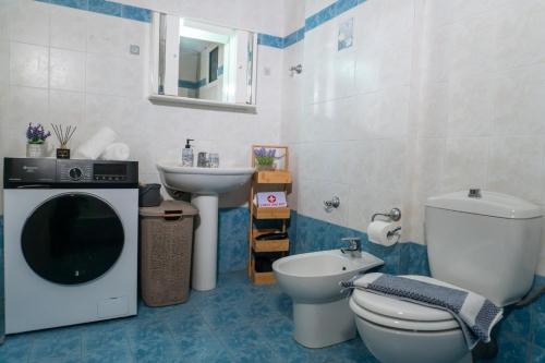 a bathroom with a toilet and a sink at Olive Harmony House in Ariokhórion