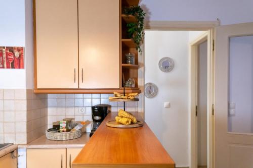 a kitchen with a counter with bananas on a plate at Olive Harmony House in Ariokhórion