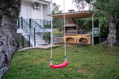 a hammock in the yard of a house at Olive Harmony House in Ariokhórion