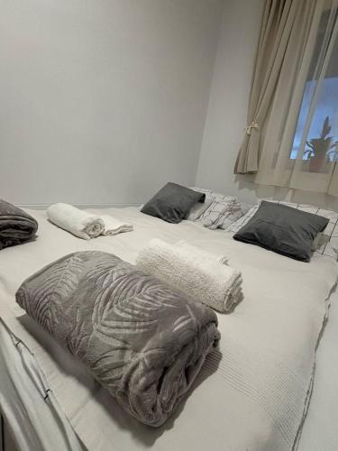 two beds with blankets on them in a bedroom at Taki apartman in Debrecen
