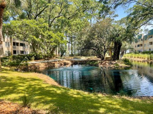 a small pond in the middle of a park at Coastal Retreat Villa on Port Royal Sound in Hilton Head Island