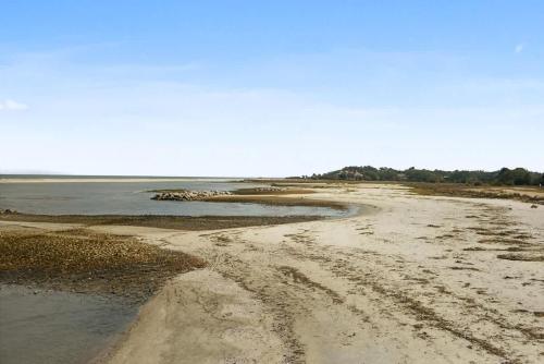 an empty beach with a dirt road and the water at Coastal Retreat Villa on Port Royal Sound in Hilton Head Island