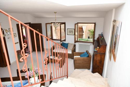 a room with a staircase and a living room at Da Minnia in Orgosolo