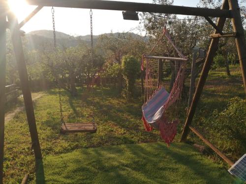 an empty swing in a yard with a field at B&B Villa Milena in Ariano Irpino